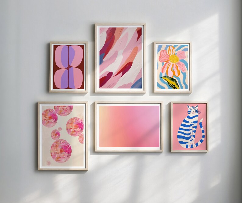 May include: A set of six framed prints with abstract and illustrative designs. The prints feature pink, blue, and white colors and include a cat, a flower, and geometric shapes.