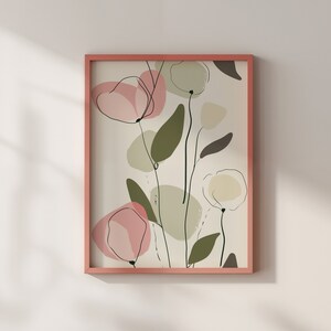 Puede incluir: Una impresi&oacute;n de arte abstracto enmarcada con formas florales rosas y verdes sobre un fondo crema. El marco es de color rosa claro.