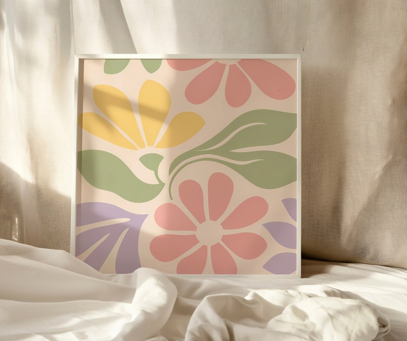 May include: A framed print with a colorful abstract floral design. The print features pink, yellow, green, and purple flowers on a light beige background.