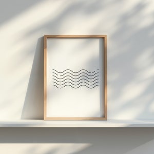 May include: A framed print with a minimalist design of black wavy lines on a white background. The frame is made of light brown wood.