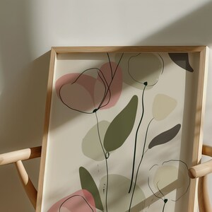 May include: A framed print with a minimalist abstract design featuring pink, green, and beige shapes and lines on a cream background.