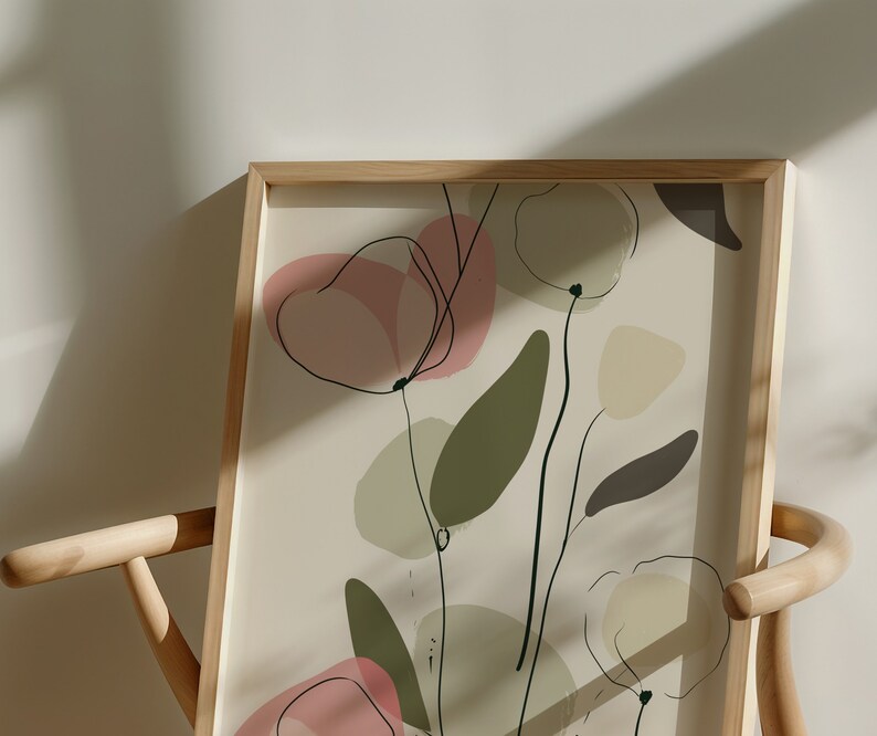 May include: A framed print with a minimalist abstract design featuring pink, green, and beige shapes and lines on a cream background.