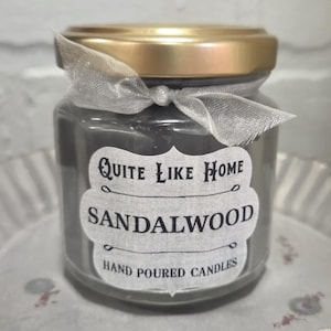 Sandalwood scented 4 oz. jar candle with gold lid, and organza ribbon