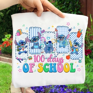 May include: White t-shirt featuring the character Stitch from Lilo & Stitch, celebrating "100 days of school." The design includes Stitch in various poses with school-themed elements like pencils, apples, and musical notes. The text is in colorful, playful lettering.