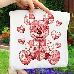 May include: White tote bag featuring a cartoon character with heart-shaped sunglasses and a patchwork design. The character is holding a heart with the word "LOVE" on it. Surrounding the character are several heart-shaped designs in red and pink.