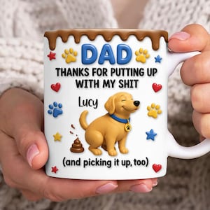 May include: White ceramic mug with a brown chocolate-like rim, featuring the word "DAD" in blue, and the text "THANKS FOR PUTTING UP WITH MY SHIT Lucy (and picking it up, too)". Includes a cartoon dog and paw prints.