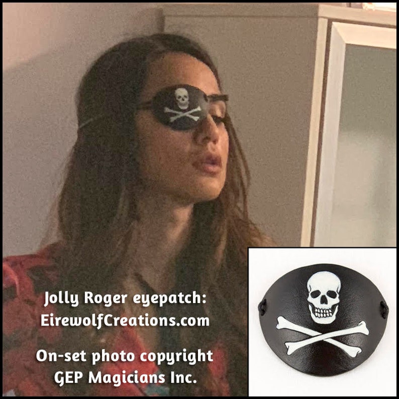 Handmade leather eyepatch with a skull-and-bones Jolly Roger carved into the leather and painted bone-white on a black background. Worn by Summer Bishil as Margo on The Magicians season 4, episodes 12 & 13.