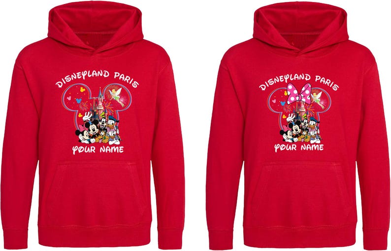 May include: Red hooded sweatshirts with "Disneyland Paris" printed above a graphic of Mickey Mouse, Minnie Mouse, Donald Duck, and Goofy. The text "Your Name" is below the graphic. One sweatshirt has a bow.
