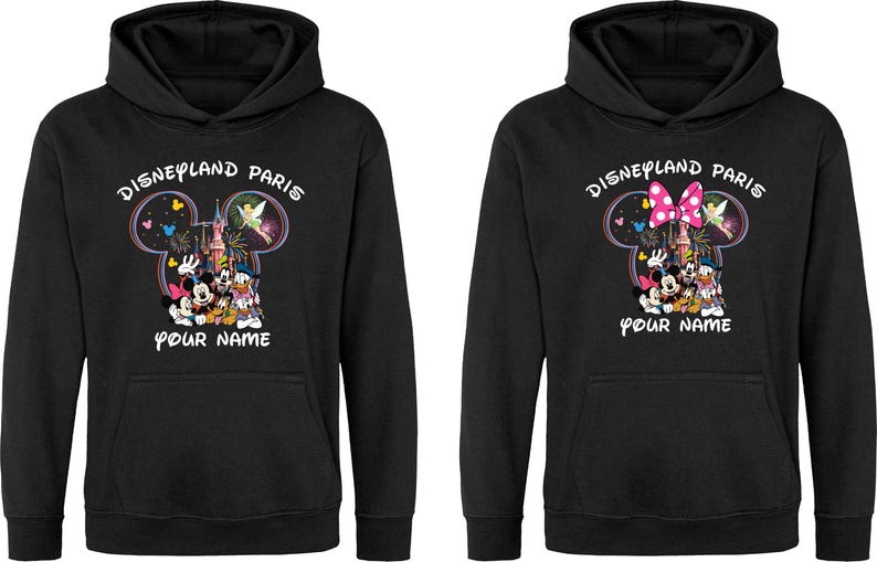 May include: Black hooded sweatshirt featuring a Disneyland Paris design. The design includes Mickey Mouse, Minnie Mouse, Donald Duck, and other characters. The text "Disneyland Paris" and "Your Name" are also visible.