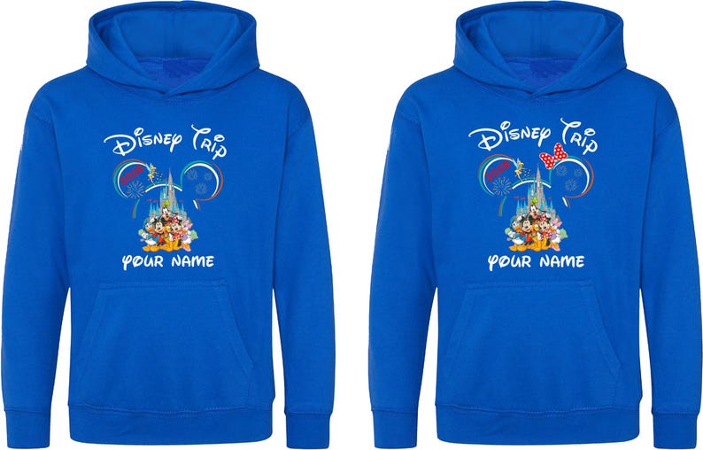 May include: Two blue hoodies with a Disney Trip design. The design includes the text "Disney Trip" above a castle and Disney characters. Below the design is the text "YOUR NAME". One hoodie has a red bow.