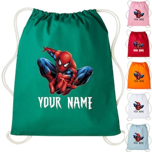 May include: A green drawstring backpack featuring a graphic of Spider-Man in red, blue, and white. The text "YOUR NAME" is printed in white below the character. Additional drawstring bags in pink, red, orange, white, and blue are also shown.