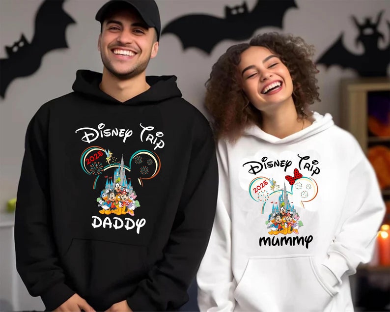 May include: Black and white hoodies with the text "Disney Trip 2025" and a graphic of Disney characters and a castle. One hoodie says "Daddy" and the other says "Mummy".