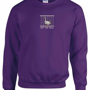 May include: Purple sweatshirt with a white goose in a cage graphic and the text "GOT TOO SILLY".