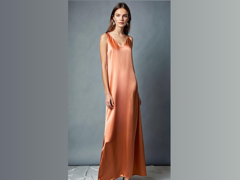 May include: A long, sleeveless, peach-colored satin dress with a V-neckline.