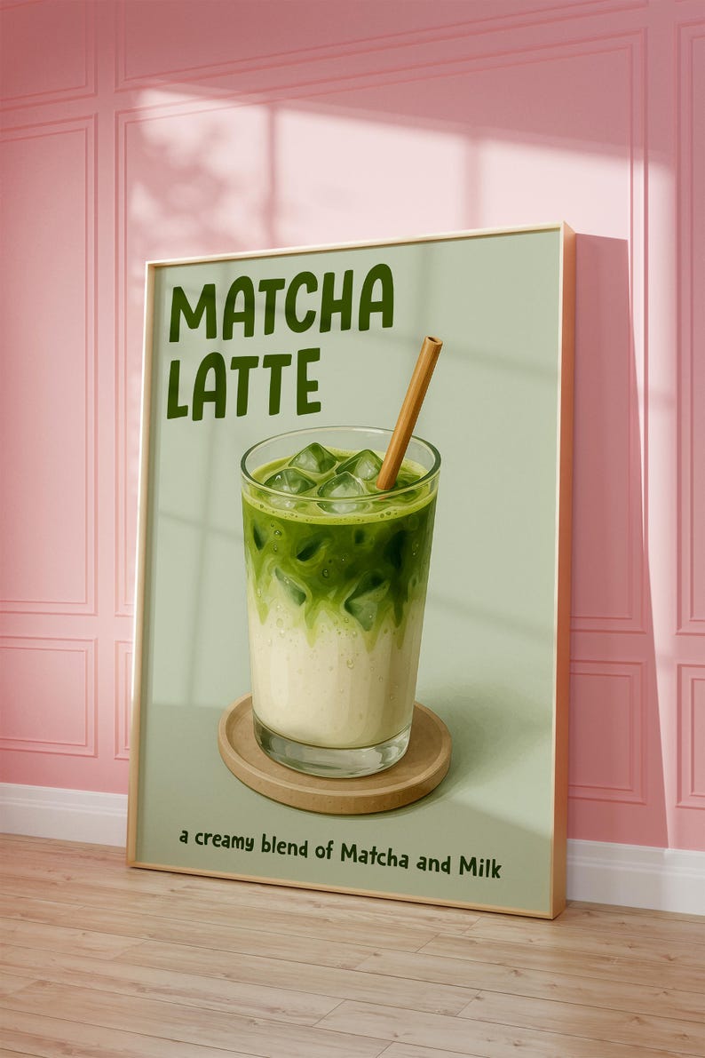 May include: Framed print of a matcha latte. The image depicts a glass of layered matcha and milk with ice cubes and a wooden straw, on a wooden coaster. The text "Matcha Latte" is at the top, with "a creamy blend of Matcha and Milk" at the bottom.