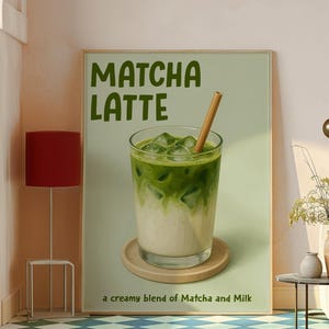 May include: A framed print depicting a matcha latte. The image shows a glass with layers of green matcha and milk, ice cubes, and a straw. The text "Matcha Latte" is at the top, with "a creamy blend of Matcha and Milk" below.