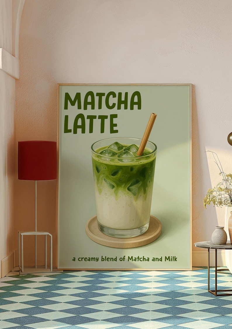 May include: A framed print depicting a matcha latte. The image shows a glass with layers of green matcha and milk, ice cubes, and a straw. The text "Matcha Latte" is at the top, with "a creamy blend of Matcha and Milk" below.