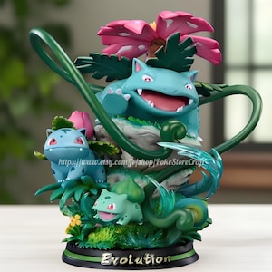 May include: A green, blue, and pink Pokemon figurine set featuring Bulbasaur, Ivysaur, and Venusaur. The figurines are posed in a dynamic way, with Venusaur standing on a rock and Bulbasaur and Ivysaur sitting on leaves. The base of the figurine is decorated with green leaves and flowers. The figurine is labeled "Evolution".