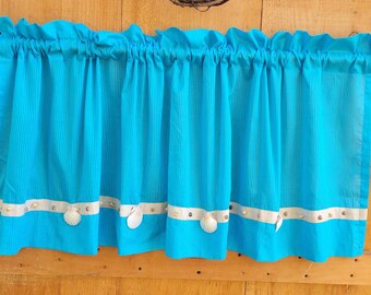 Sheer turquoise valances with seashell trim