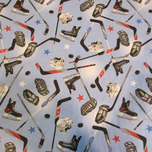 Hockey Sticks Helmets and Pucks Light Blue Mook Flannel Fabric - BTY