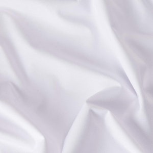 May include: White fabric with soft folds and wrinkles. The fabric is smooth and has a subtle sheen.