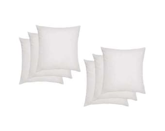May include: Set of six white square throw pillows. The pillows are made of a soft, comfortable fabric and are perfect for adding a touch of style to any room.