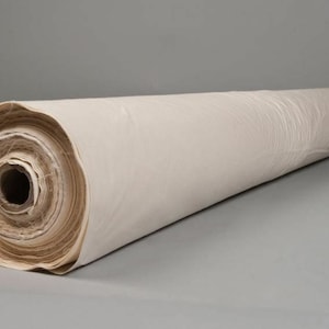 May include: A roll of white canvas fabric, tightly wound and ready for use. The fabric is smooth and unblemished, perfect for painting or crafting.