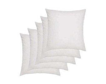 May include: Set of five white pillow inserts. The pillows are arranged in a stack, with the largest pillow at the bottom and the smallest pillow at the top.