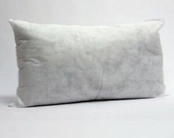 May include: White pillow insert for a standard size pillow. The pillow is made of a soft, fluffy material and is perfect for sleeping or lounging.