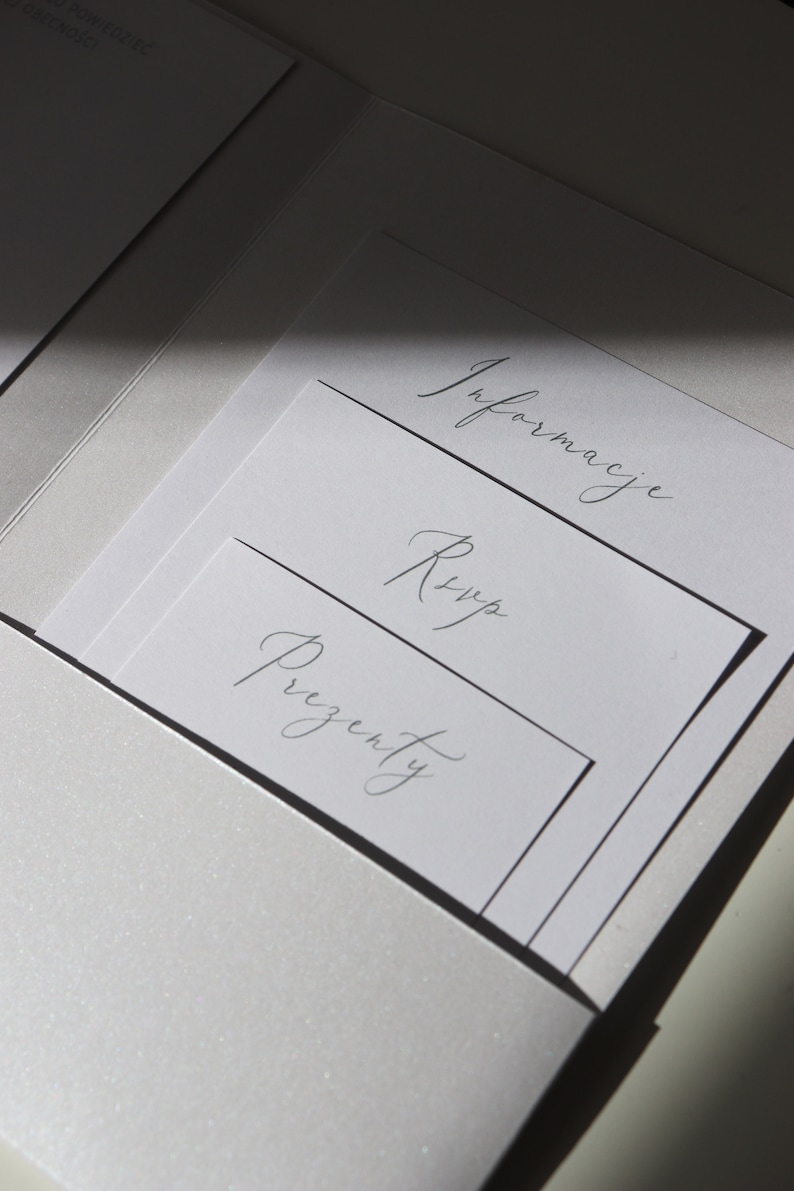 May include: A white envelope with three white cards inside. The cards are labeled "Information", "RSVP", and "Presents".