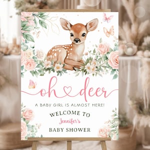 May include: A baby shower welcome sign featuring a watercolor illustration of a fawn surrounded by pink roses and greenery. The sign reads "oh deer" and welcomes guests to Jennifer's baby shower. Butterflies add a whimsical touch.