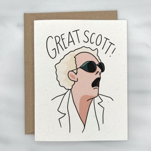 May include: A greeting card with a cartoon illustration of a man with blonde hair wearing sunglasses and a white lab coat. The text "GREAT SCOTT!" is written above the illustration.