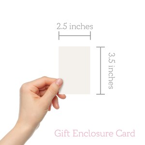 May include: A blank white gift enclosure card measuring 2.5 inches by 3.5 inches. The card is held in a hand.