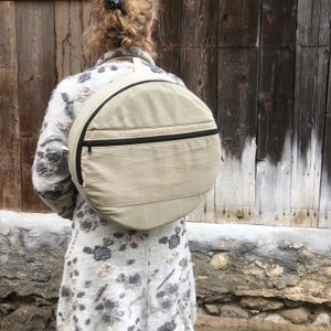 Drum bags in.  cotton. kaki color with front zip pocket.