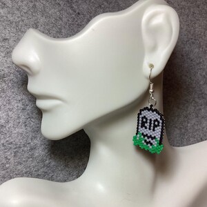 A GRAVE pair of earrings