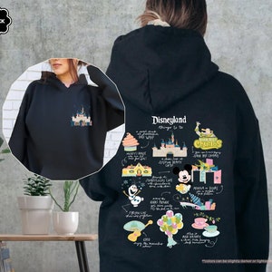 a woman wearing a black disneyland hoodie