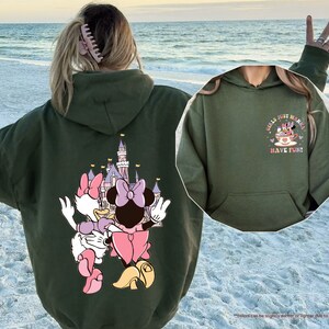 a woman wearing a hoodie with a cartoon character on it