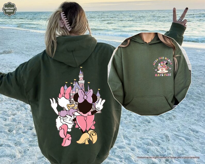 a woman wearing a hoodie with a cartoon character on it