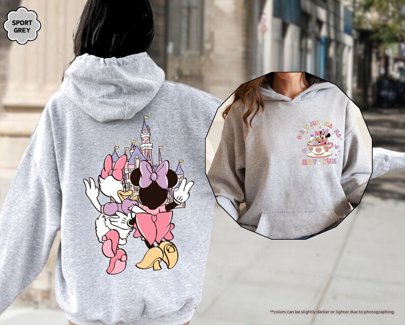 a woman wearing a mickey mouse hoodie on the street
