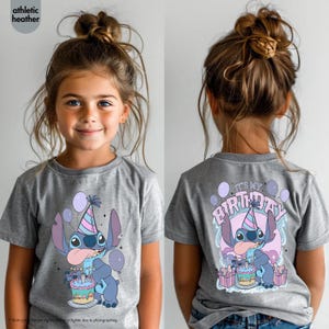 May include: Grey t-shirt with a cartoon character design, a party hat, cake, and balloons. The front and back of the shirt show the character with the text "IT'S MY BIRTHDAY".