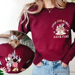 a woman wearing a sweatshirt with a cartoon character on it