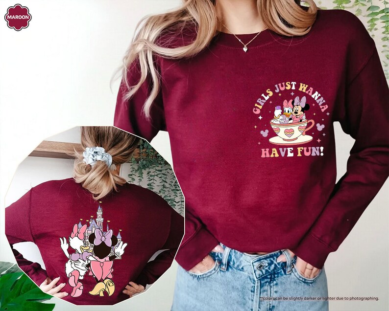 a woman wearing a sweatshirt with a cartoon character on it