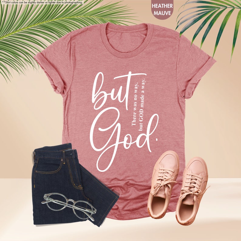 a t - shirt with the words but god on it next to a pair of
