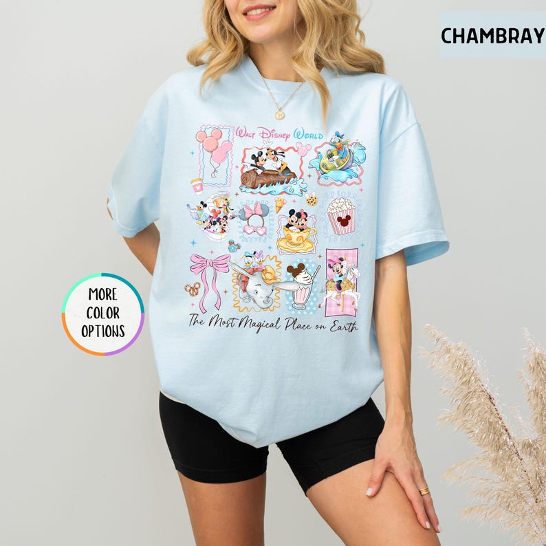 May include: Light blue t-shirt featuring a colorful collage of Disney characters and icons, including Mickey Mouse, Donald Duck, and Dumbo. The shirt has the text "Walt Disney World" and "The Most Magical Place on Earth".