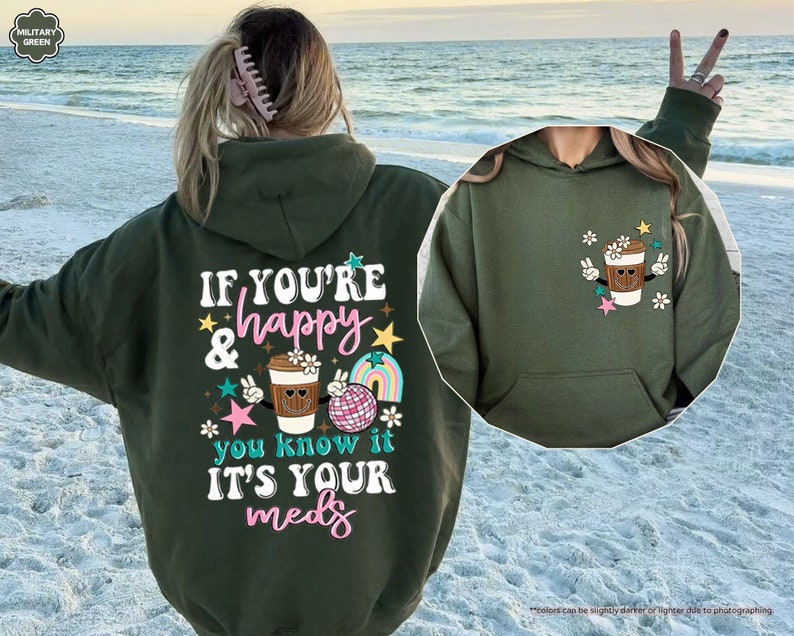 a woman wearing a green hoodie with a cupcake on it
