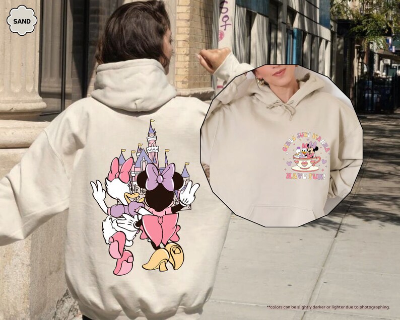 a person wearing a mickey mouse hoodie on a city street