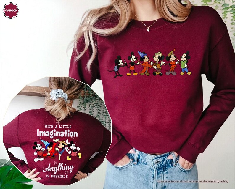 Puede incluir: Sudadera granate con una fila de personajes de dibujos animados en el pecho. La parte posterior de la sudadera muestra el texto "WITH A LITTLE Imagination Anything IS POSSIBLE" con personajes de dibujos animados.