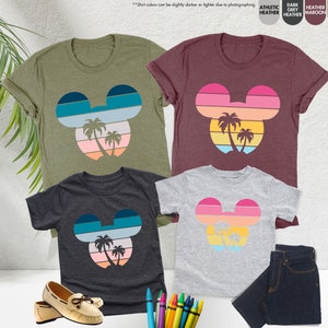 three t - shirts with mickey mouse faces on them