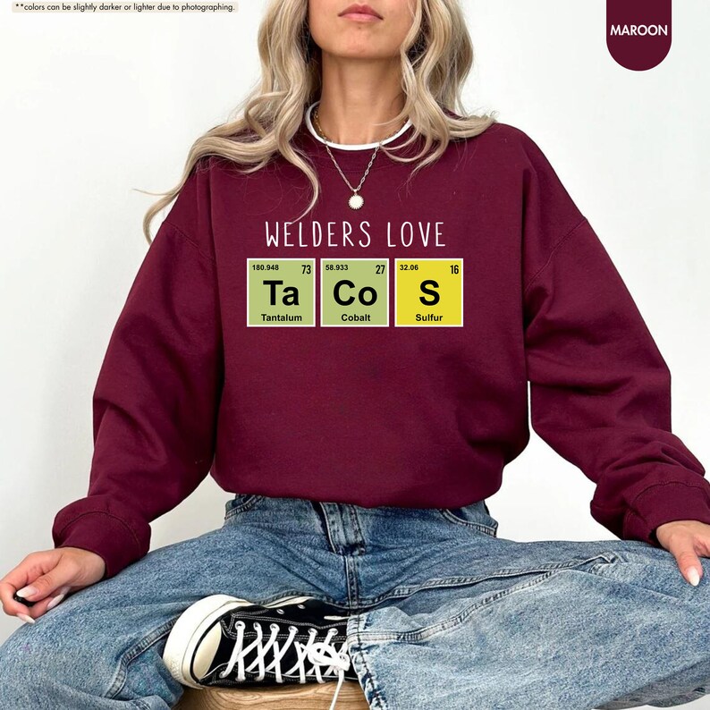 a woman sitting on a stool wearing a sweatshirt with the words welders love