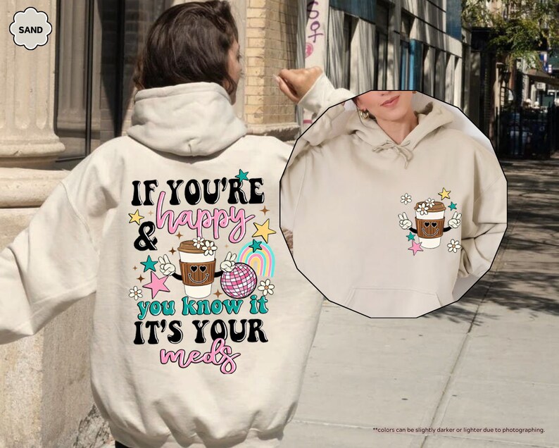 a person wearing a white hoodie with a cup of coffee on it